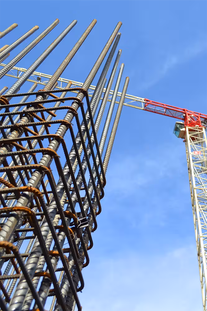 Low angle view of crane and rebar structure